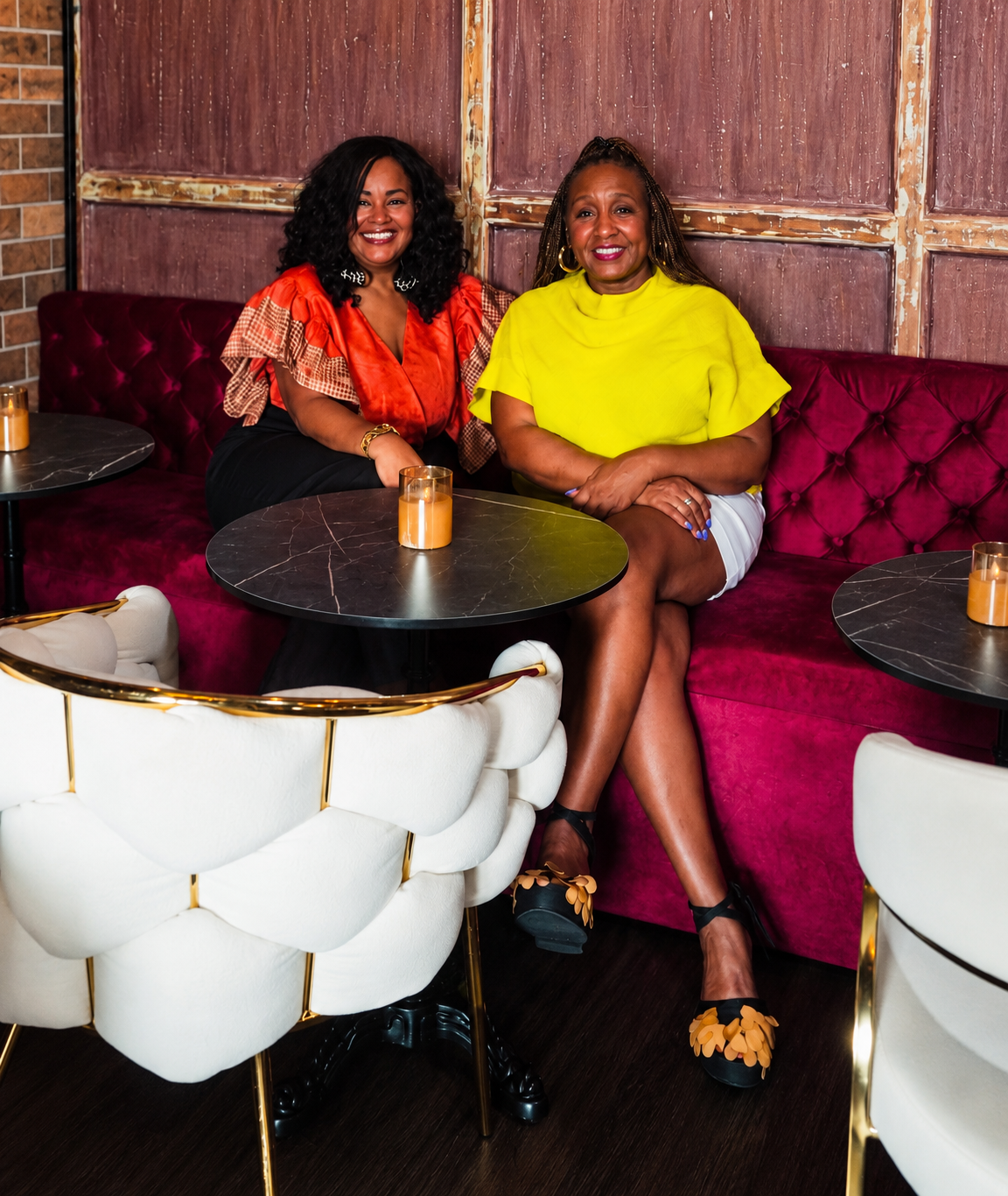Lori and Ayanna of Oud & Shuga seated together in the showroom